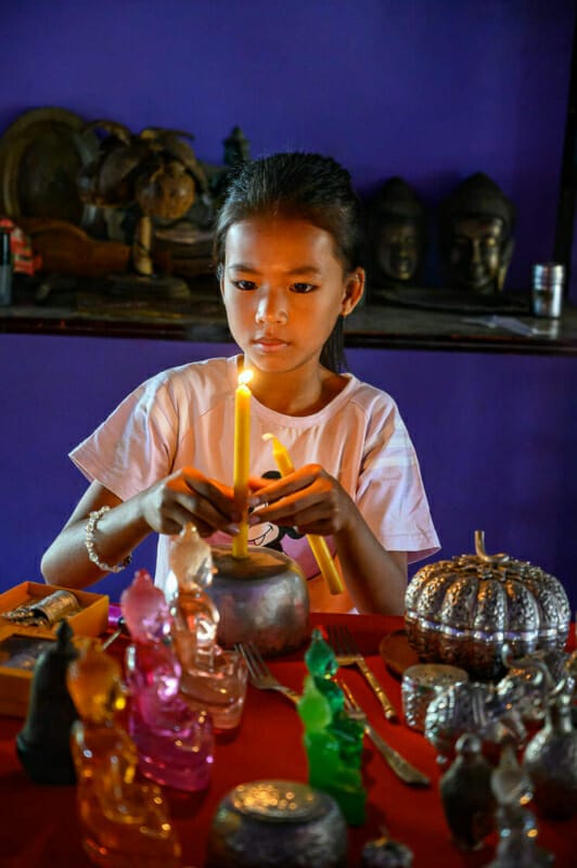 Lighting Candles Lighting Candles - Kampong Luong Silversmith Village - Rural Cambodia - Street Photography Documentary